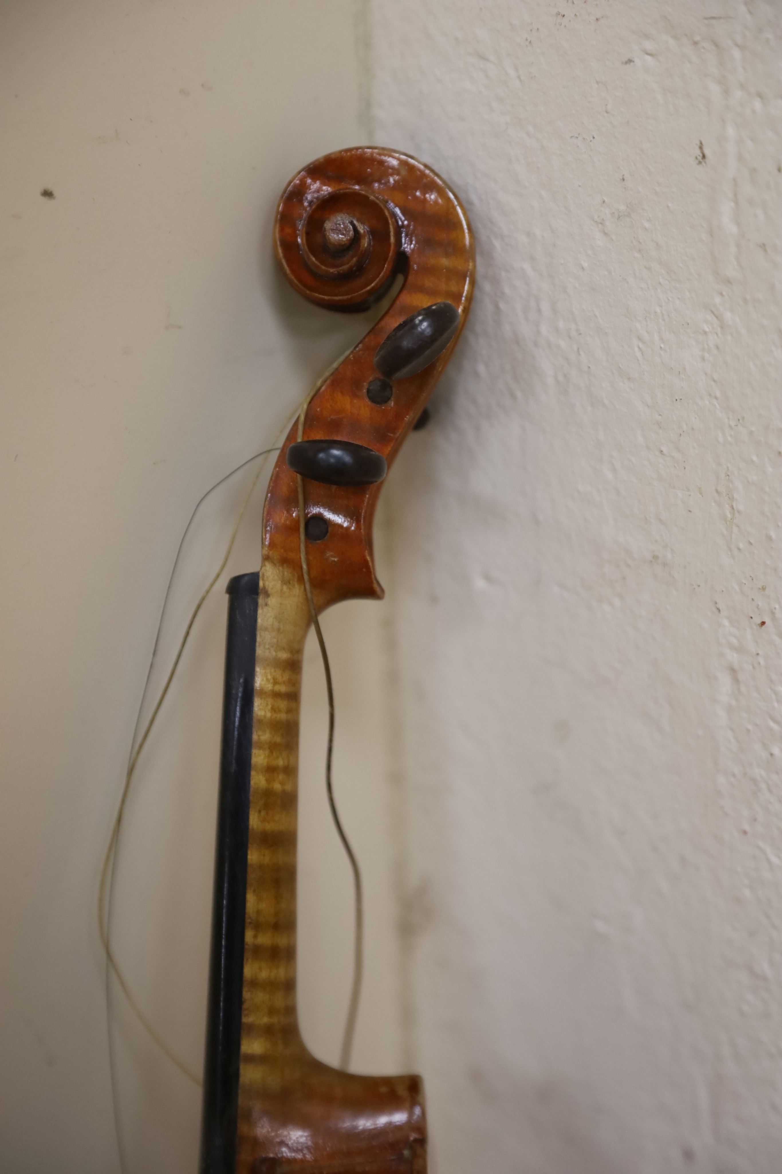 A Stradivarius copy violin and two bows and another bow, both cased, backs 33cm and 30cm